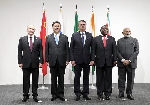 Russian President Vladimir Putin, China's President Xi Jinping, Brazilian President Jair Bolsonaro, South African President Cyril Ramaphosa and Indian Prime Minister Narendra Modi pose for a photo prior to a BRICS meeting on the sidelines of the G-20 summ
