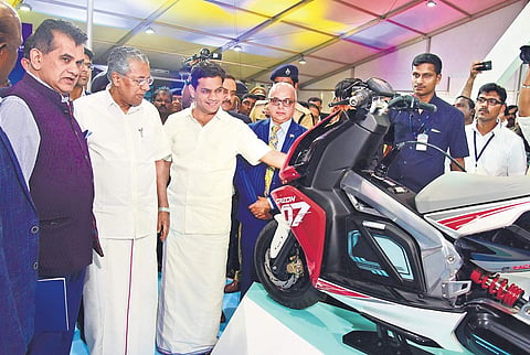 Chief Minister Pinarayi Vijayan flanked by Ernakulam MP Hibi Eden and Niti Aayog CEO Amitabh Kant takes a close look at an electric bike displayed at the Kerala E-Mobility Expo 2019 at Grand Hyatt, Bolgatty in Kochi on Saturday. Chief Secretary Tom Jose i