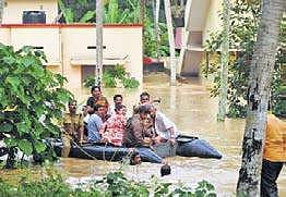 Fire and Rescue Services personnel relocating a family from their house at Maruthankuzhy in Thiruvananthapuram during the deluge last year (file pic)