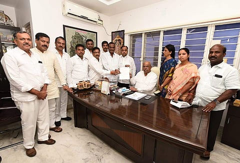 The 12 Congress MLAs who defected to the TRS are seen with state legislative assembly speaker Pocharam Srinivas Reddy at his residence in the Ministers' Quarters in Hyderabad on 6 June 2019. They submitted a representation seeking to merge the Congress Le