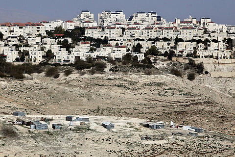 The Israeli settlement of Maaleh Adumim looms over Arab Bedouin shacks in the West Bank (File Photo | AP)
