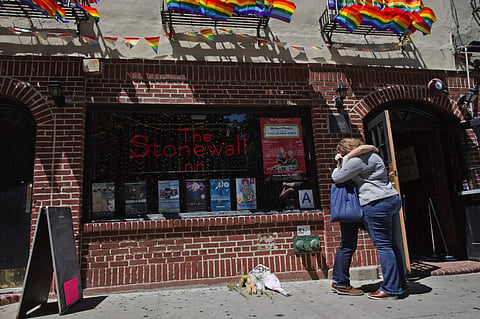 A couple embraces outside the Stonewall Inn in New York. (Photo | AP)