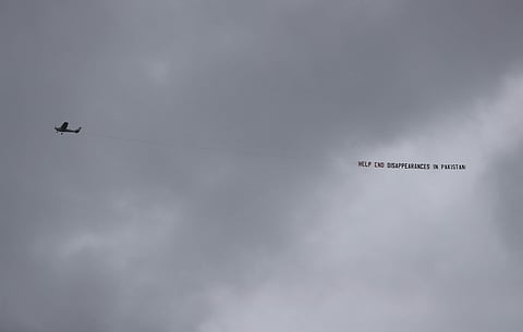 An aircraft tows a banner that reads 'Help end disappearances in Pakistan' as it flies over the venue of the Cricket World Cup semi-final match between England and Australia at Edgbaston in Birmingham. (Photo | AP)