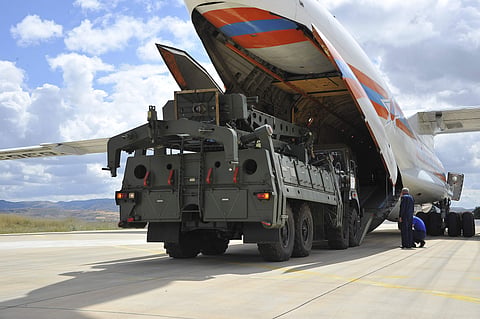 Military vehicles and equipment, parts of the S-400 air defense systems, are unloaded from a Russian transport aircraft, at Murted military airport in Ankara, Turkey ( Photo |AP)