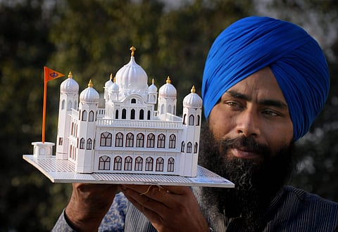 Paper artist Gurpreet Singh shows his creation a paper model of Guru Nanak Dev Ji's gurudwara Kartarpur Sahib in Pakistan in Amritsar Thursday Nov. 22 2018.  (File | PTI)