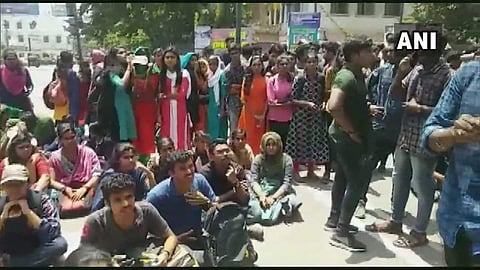 Students of University College protested outside the college after a 3rd year student got stabbed in a clash that broke out between the members of SFI and other students of the college, today. (Photo | ANI Twitter)