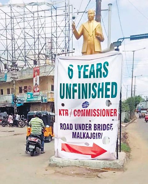 Malkajgiri residents put up a flexi seeking completion of the pending RuB works at Anand Bagh in Hyderabad on Sunday| Express