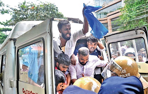 Police removing KSU activists who staged protest in front of District Collector’s camp office on Monday demanding the arrest of all accused involved in the murder of SFI leader M Abhimanyu at Maharaja’s College  | A Sanesh