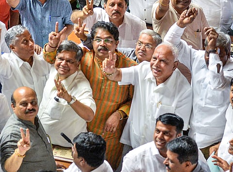 BJP State President BS Yeddyurappa with his party MLAs show victory sign after HD Kumaraswamy lost the vote of confidence during Assembly Session at Vidhana Soudha in Bengaluru Tuesday July 23 2019.  | PTI