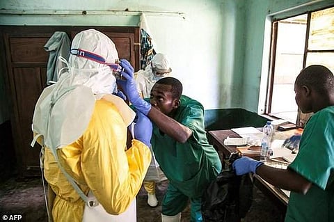 Health workers don protective gear before examining suspected Ebola patients at Bikoro hospital in DR Congo's Equateur province. (Photo | AFP)