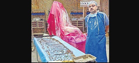 The surgeon with the ornaments and coins recovered from the Bengal woman's stomach. (Photo | EPS)