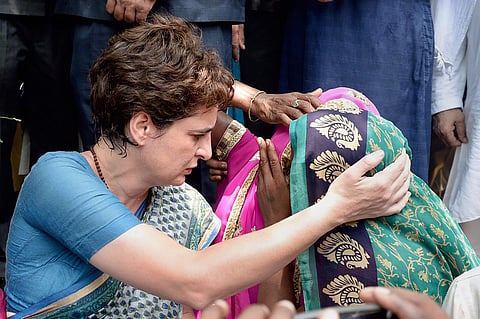 Congress General Secretary Priyanka Gandhi Vadra consoles a family member of a Sonbhadra massacre victim who had travelled to Chunar Fort to meet her after the former was stopped from proceeding to Sonbhadra in Mirzapur on 20 July 2019. (Photo | PTI)