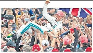 Hamilton crowdsurfing after his victory in Britain