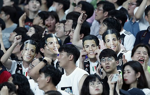 South Korean soccer fans wear masks of Cristiano Ronaldo | AP
