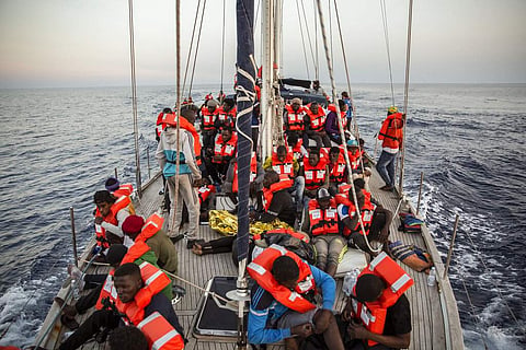 Migrants rest on a Mediterranea Saving Humans NGO boat, as they sail off Italy's southernmost island of Lampedusa (Photo | AP)