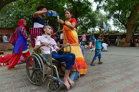 A patient on a wheelchair being attended to by his relatives outside the LNJP Hospital during a strike by the resident doctors in New Delhi on 8 July 2019. (Photo | PTI)