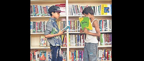Children reading books at a library. ( Photo | EPS)