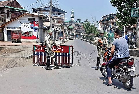 Security forces stop people during restrictions imposed in Srinagar. | Zahoor Punjabi