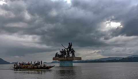 A passenger boat ferries across people while dark clouds hover over river Brahmaputra in Guwahati (File photo | PTI)