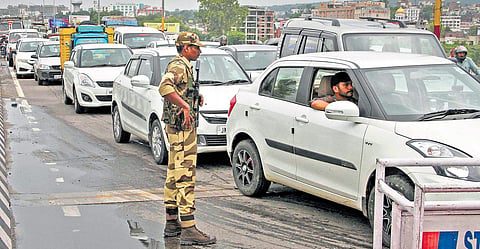 A security personnel stands guard as vehicles plied normally after five days of security clampdown in Jammu on Saturday | PTI