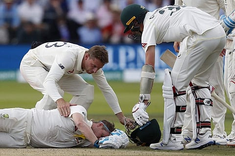 Australia's Steve Smith lays on the pitch after being hit in the head by a ball off the bowling of England's Jofra Archer (unseen) during play on the fourth day of the second Ashes cricket Test match between England and Australia at Lord's Cricket Ground.
