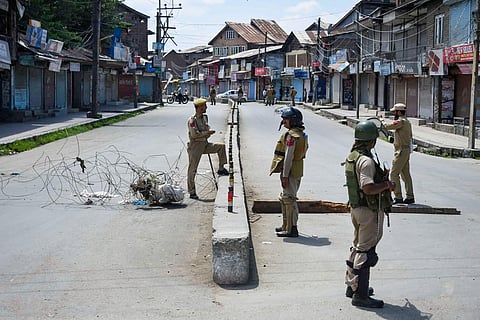 Security personnel stand guard at a check point during restrictions after Centre abrogated Article 370 and divided Jammu and Kashmir into two union territories in Srinagar Sunday August 18 2019. | PTI