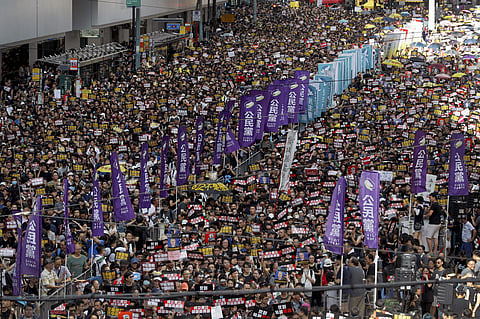 Thousands of Hong Kong protesters marched from a public park to call for an independent investigation into police tactics.  (Photo | AP)
