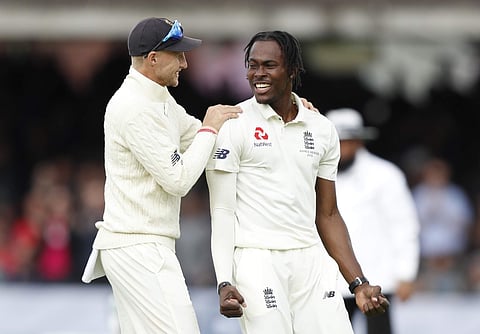 England's captain Joe Root congratulates England's bowler Jofra Archer. (Photo | AP)