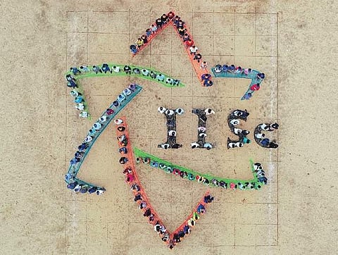 (Above) Students and faculty members of Indian Institute of Science make a formation of their new logo, in Bengaluru,  on Tuesday; (Left) A student protests against the logo by sporting a printout of a detergent company logo on his T-shirt