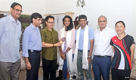 PV Sindhu and Kiren Rijiju along with Badminton Association of India president Himanta Biswa Sarma, coaches Pullela Gopichand and Kim Ji-Hyun and Sindhu's father P V Ramana, a former bronze medallist in volleyball at the 1986 Asian Games. (Photo | Twitter