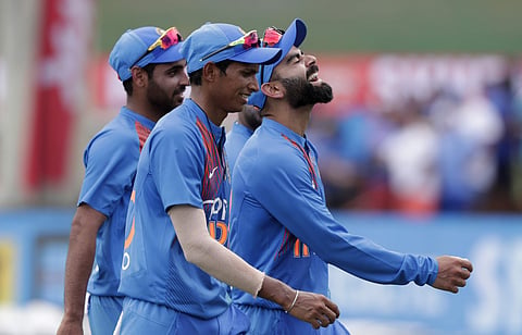 Navdeep Saini (C) walks off the field with Virat Kohli (R) and Bhuvenshwar Kumar. (Photo | AP)