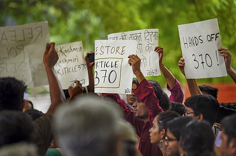 Activists of AISA, CPI-M and other organisations display placards during a protest against the union government's move to revoke Article 370 in Jammu Kashmir in New Delhi on 5 August 2019. (Photo | PTI)