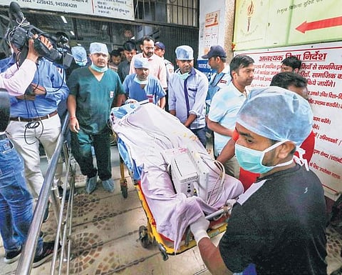 The lawyer of the Unnao rape survivor is wheeled by medical attendants outsidethe KGMC Trauma Centre in Lucknow for facilitating his airlift to New Delhi on Tuesday | PTI