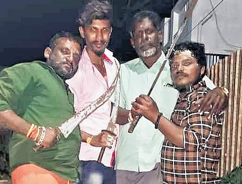 Photo of the group celebrating holding two-foot-long knives