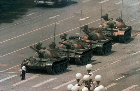 The seven-week-long Tiananmen Square protests and their bloody end — hundreds if not thousands of people are believed to have died. This June 5 1989 photo, later came to be known as the 'tank man.' taken by Charlie Cole. (Photo | AP)