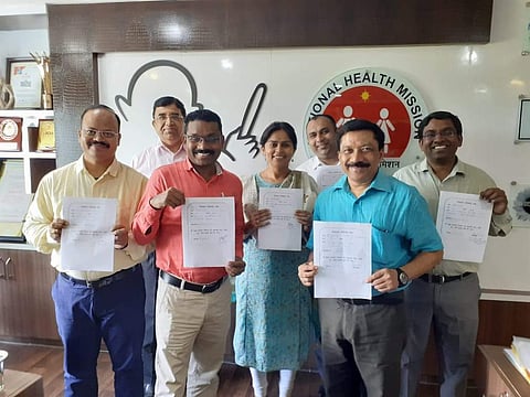 Civil servants in Chhattisgarh holding a pledge form they had signed for eye donation.