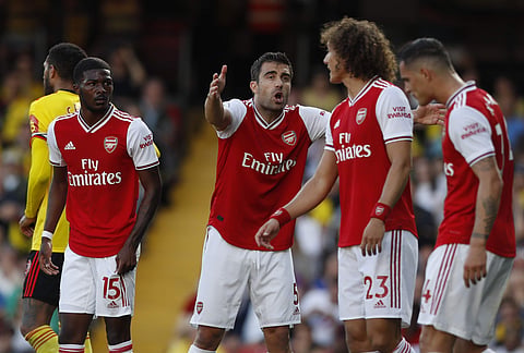Arsenal's Sokratis Papastathopoulos, center, gestures as he shouts at his teammates during their EPL encounter against Watford. (Photo | AP)