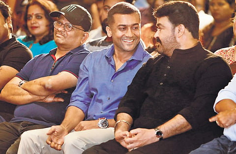 Mohanlal and Suriya sharing a light moment  at the promotions of Kaappaan  in Kochi on Tuesday. Director  K V Anand is also seen. (Photo | ARUN ANGELA, EPS)