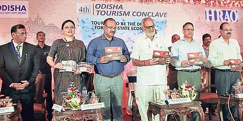 Governor Prof Ganeshi Lal unveiling ‘Tourism Booklet on Western Odisha’ during 4th Odisha Tourism Conclave in Bhubaneswar on Wednesday  | Express
