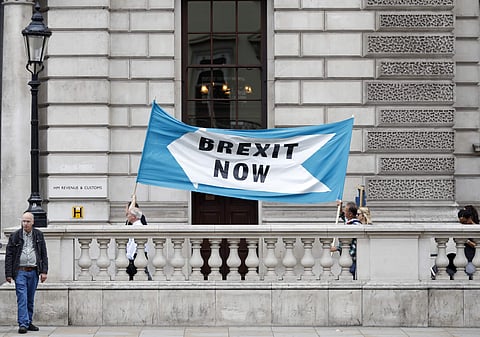 Pro Brexit demonstrators parade their banner past the Treasury building in London. (Photo | AP)