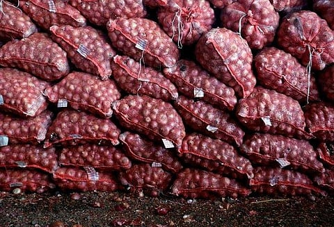 Packed sacks of onions kept for delivery. (Photo | Reuters)