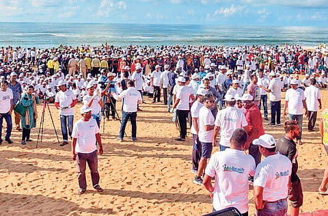Volunteers gather on Puri beach and perform yoga during ‘Mo Beach Puri clean-up’ programme. ( Photo | Ranjan Ganguly )
