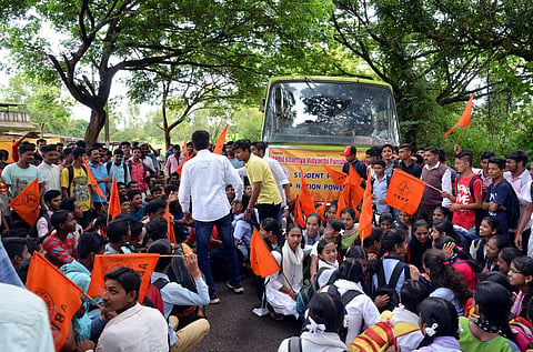 Students protesting by conducting Raasta Roko at Bekwad cross in Khanapur on Wednesday (Express Photo)
