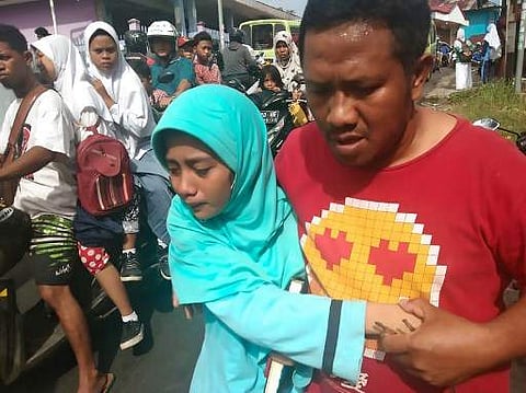 People gather outdoors at Batu Merah village in Ambon, Indonesia's Maluku islands, following a 6.5-magnitude earthquake on September 26, 2019. (Photo | AFP)