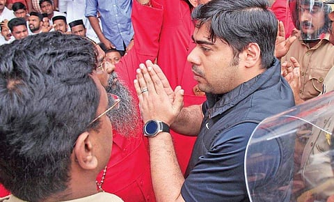To calm down protesters, Ernakulam District Collector S Suhas enters the church with folded hands
