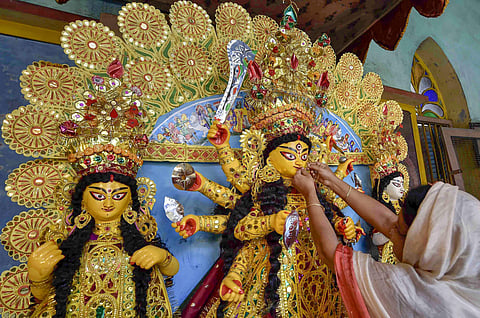 An idol of Goddess Durga being decorated with gold ornaments at a traditional 189 years old puja house on Mahashasthi of Durga Puja festival in Kolkata Monday Oct 15 2018. (File Photo | PTI)