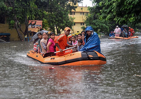 State Disaster Response Force SDRF workers rescue people from flood-affected area of Bahadurpur following heavy monsoon rainfall in Patna.