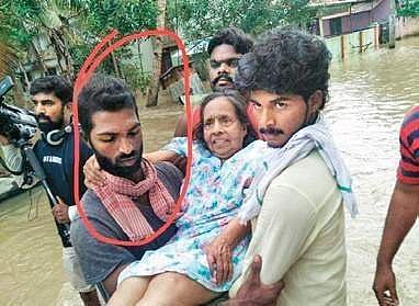 A file picture of Jinesh helping a woman during 2018 flood
