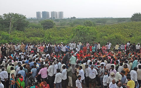 Villagers sat on road after police blocks them for taking protest rally to Kanaka Durga temple against three capitals for Andhra Pradesh at Rayapudi in Amaravathi on Friday| Prasant Madugula