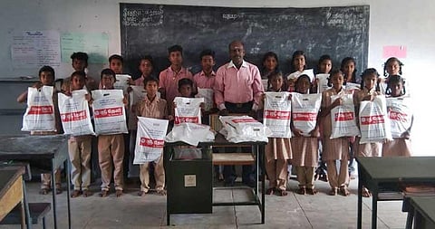 Sai Senthilnathan with students of Barali government high school to whom he provided new clothes ahead of Pongal festival (Photo | EPS)